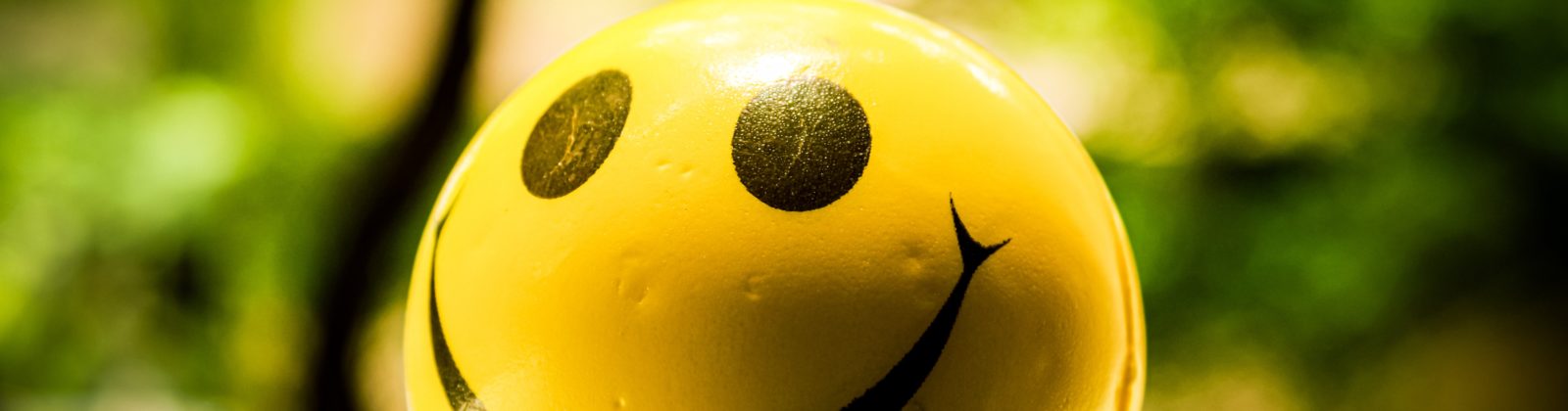 A picture of a happy emoji aligned to customer sentiment